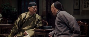 Movie still from “Fearless” (2006), directed by Ronny Yu – Two men are sitting at a table talking to each other; Medium shot, Over the shoulder angle