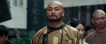Movie still from “Fearless” (2006), directed by Ronny Yu – A man with a bald head wearing a robe; Close Up shot, Low angle