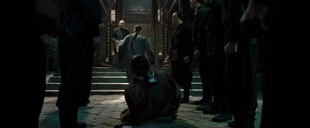 Movie still from “Fearless” (2006), directed by Ronny Yu – A group of people standing around a building; Wide shot, High angle