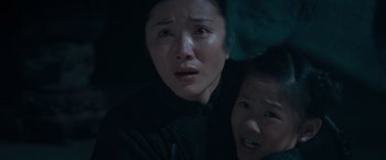 Movie still from “Fearless” (2006), directed by Ronny Yu – Two people are crying in the dark; Close Up shot, High angle
