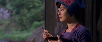 Movie still from “Fearless” (2006), directed by Ronny Yu – A woman holding chopsticks in her hands; Close Up shot, Over the shoulder angle