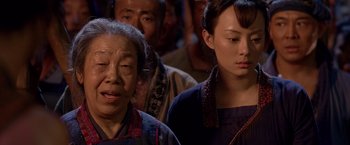 Movie still from “Fearless” (2006), directed by Ronny Yu – A group of people standing next to each other in a room; Close Up shot, Over the shoulder angle