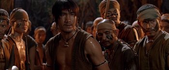 Movie still from “Fearless” (2006), directed by Ronny Yu – A group of men in native dress standing next to each other; Medium shot, Over the shoulder angle
