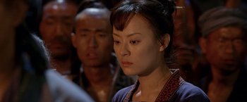 Movie still from “Fearless” (2006), directed by Ronny Yu – A person with a person in the background; Close Up shot, Over the shoulder angle