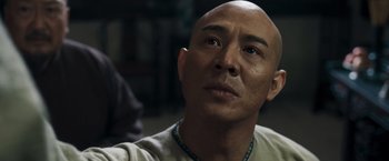 Movie still from “Fearless” (2006), directed by Ronny Yu – A man with a bald head looking upward; Close Up shot, Low angle