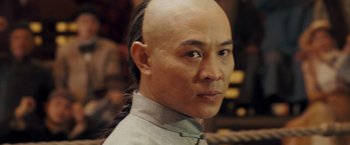 Movie still from “Fearless” (2006), directed by Ronny Yu – A man with a bald head is looking at the camera; Close Up shot, Over the shoulder angle