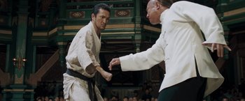 Movie still from “Fearless” (2006), directed by Ronny Yu – Two men are fighting in front of an audience; Medium shot, Low angle