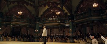 Movie still from “Fearless” (2006), directed by Ronny Yu – A man walking on a stage in front of an audience; Extreme Wide shot, High angle