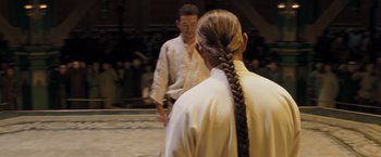 Movie still from “Fearless” (2006), directed by Ronny Yu – A man and a woman are standing in front of each other; Medium shot, Over the shoulder angle
