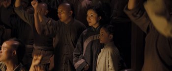 Movie still from “Fearless” (2006), directed by Ronny Yu – A group of people standing next to each other in the dark; Medium shot, Low angle