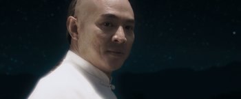 Movie still from “Fearless” (2006), directed by Ronny Yu – A man with a bald head is posing for a picture; Close Up shot, Low angle