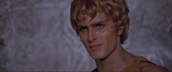 Movie still from “Fellini Satyricon” (1969), directed by Federico Fellini – A person wearing a wig; Close Up shot, Over the shoulder angle