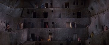 Movie still from “Fellini Satyricon” (1969), directed by Federico Fellini – A group of people standing on top of a building; Extreme Wide shot, High angle