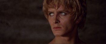 Movie still from “Fellini Satyricon” (1969), directed by Federico Fellini – A person's face in a dark room; Close Up shot, Low angle