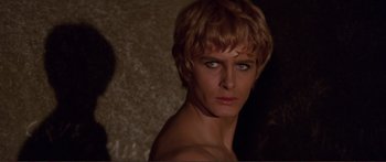 Movie still from “Fellini Satyricon” (1969), directed by Federico Fellini – A person with short blonde hair; Close Up shot, Over the shoulder angle