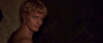 Movie still from “Fellini Satyricon” (1969), directed by Federico Fellini – A person with short blonde hair; Close Up shot, Over the shoulder angle