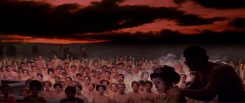 Movie still from “Fellini Satyricon” (1969), directed by Federico Fellini – A large group of people standing next to each other; Extreme Wide shot, High angle