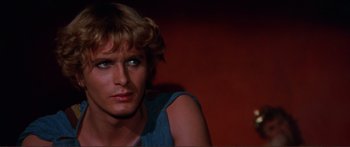 Movie still from “Fellini Satyricon” (1969), directed by Federico Fellini – A person wearing a blue shirt; Close Up shot, Over the shoulder angle