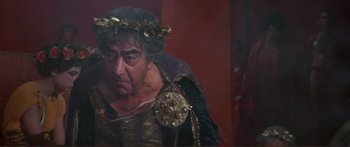 Movie still from “Fellini Satyricon” (1969), directed by Federico Fellini – A person wearing a crown; Medium shot, Over the shoulder angle