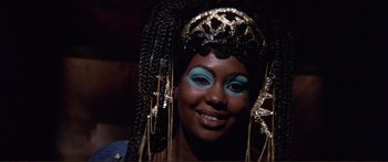 Movie still from “Fellini Satyricon” (1969), directed by Federico Fellini – A woman with blue eyes and blue and black makeup; Close Up shot, High angle
