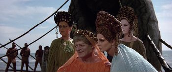 Movie still from “Fellini Satyricon” (1969), directed by Federico Fellini – A man and two women in fancy headpieces; Medium shot, Low angle