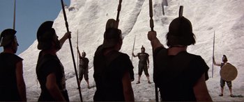 Movie still from “Fellini Satyricon” (1969), directed by Federico Fellini – A group of people standing on top of a snow covered slope; Wide shot, Low angle