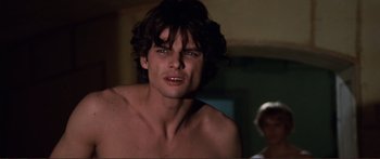 Movie still from “Fellini Satyricon” (1969), directed by Federico Fellini – A person wearing a shirt; Close Up shot, Over the shoulder angle