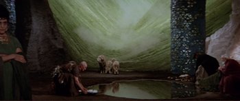 Movie still from “Fellini Satyricon” (1969), directed by Federico Fellini – A group of sheep standing next to each other near water; Wide shot, High angle