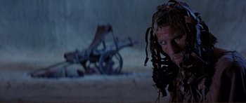 Movie still from “Fellini Satyricon” (1969), directed by Federico Fellini – A person wearing a dreadlock wig; Close Up shot, Low angle