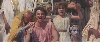 Movie still from “Fellini Satyricon” (1969), directed by Federico Fellini – A group of people dressed in ancient roman clothing; Medium shot, Low angle