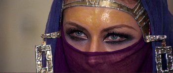 Movie still from “Fellini Satyricon” (1969), directed by Federico Fellini – A person with blue eyes wearing a veil; Close Up shot, Overhead angle