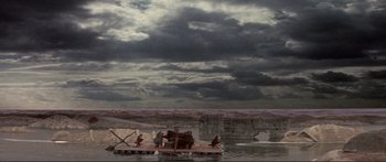 Movie still from “Fellini Satyricon” (1969), directed by Federico Fellini – An image of an elephant on a raft in the middle of a river; Extreme Wide shot, Low angle