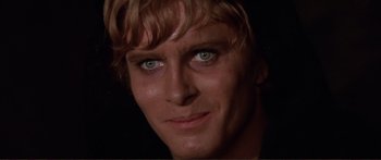 Movie still from “Fellini Satyricon” (1969), directed by Federico Fellini – A man's face in the dark; Close Up shot, Over the shoulder angle