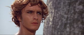 Movie still from “Fellini Satyricon” (1969), directed by Federico Fellini – A man's face in front of a tree; Close Up shot, Over the shoulder angle