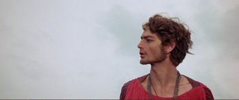 Movie still from “Fellini Satyricon” (1969), directed by Federico Fellini – A person wearing a red shirt; Close Up shot, Low angle