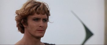 Movie still from “Fellini Satyricon” (1969), directed by Federico Fellini – A man's face with a sky in the background; Close Up shot, Over the shoulder angle