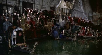 Movie still from “Fellini's Casanova” (1976), directed by Federico Fellini – A group of people sitting on a boat in the middle of the water; Extreme Wide shot, High angle