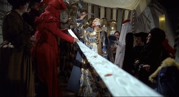 Movie still from “Fellini's Casanova” (1976), directed by Federico Fellini – A group of people dressed in costumes in a room; Medium shot, High angle