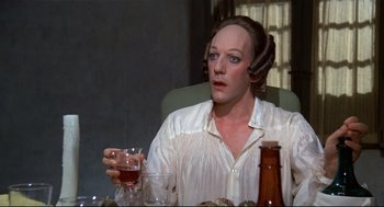 Movie still from “Fellini's Casanova” (1976), directed by Federico Fellini – A woman in a white shirt holding a glass of wine; Close Up shot, High angle