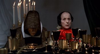 Movie still from “Fellini's Casanova” (1976), directed by Federico Fellini – A couple of people sitting at a dinner table; Medium shot, High angle