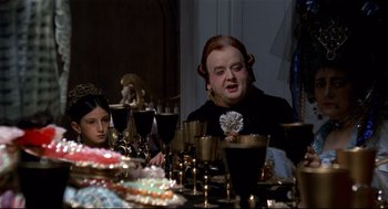 Movie still from “Fellini's Casanova” (1976), directed by Federico Fellini – Two people sitting at a dinner table with wine glasses; Medium shot, Over the shoulder angle