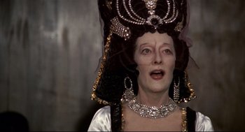Movie still from “Fellini's Casanova” (1976), directed by Federico Fellini – An older woman wearing a crown and a necklace; Close Up shot, Over the shoulder angle