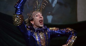 Movie still from “Fellini's Casanova” (1976), directed by Federico Fellini – A man in a blue and gold costume with his mouth wide open; Medium shot, Low angle