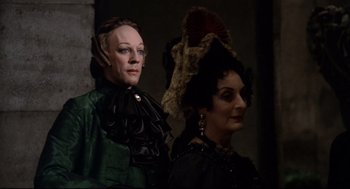 Movie still from “Fellini's Casanova” (1976), directed by Federico Fellini – A couple of people that are dressed up; Medium shot, Low angle