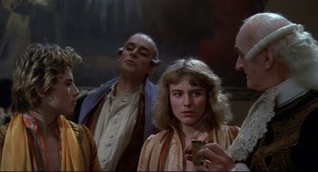 Movie still from “Fellini's Casanova” (1976), directed by Federico Fellini – A group of people standing next to each other in a room; Medium shot, Over the shoulder angle