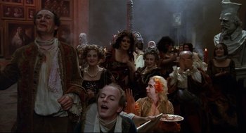 Movie still from “Fellini's Casanova” (1976), directed by Federico Fellini – A group of people dressed up in costumes; Medium shot, High angle