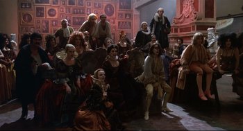 Movie still from “Fellini's Casanova” (1976), directed by Federico Fellini – A group of people dressed in medieval clothing; Wide shot, High angle