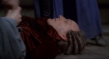 Movie still from “Fellini's Casanova” (1976), directed by Federico Fellini – A woman laying on the floor with her head on the ground; Medium shot, High angle