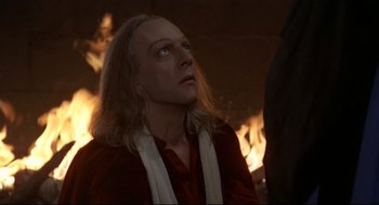 Movie still from “Fellini's Casanova” (1976), directed by Federico Fellini – A man with long blonde hair wearing a red shirt; Close Up shot, High angle