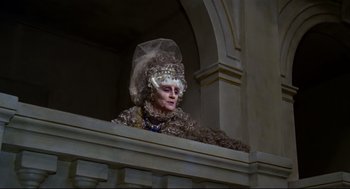 Movie still from “Fellini's Casanova” (1976), directed by Federico Fellini – An older woman wearing a fancy dress outfit; Medium shot, Low angle